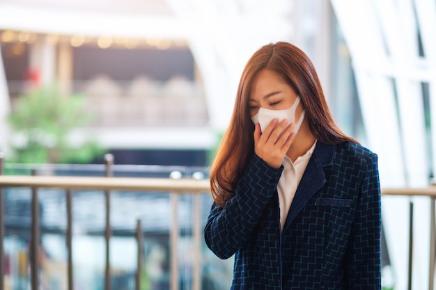 Closeup image of a sick woman wearing protective face mask for Healthcare and Covid-19 or 2020 virus concept