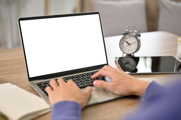 Closeup image of a smart asian male college student using laptop laptop mockup