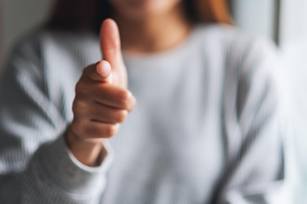 Closeup image of a woman pointing finger at you