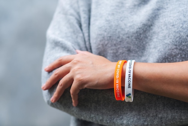 Closeup image of a woman wearing I got my covid19 vaccine wristband for health care concept