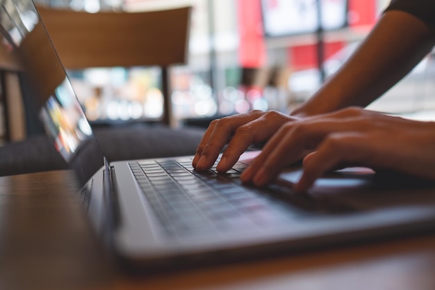 Photo closeup image of a woman working and typing on laptop computer keyboard