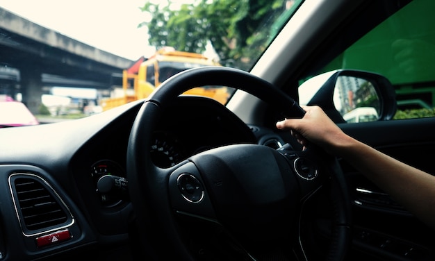 Closeup images of woman hands driving and controling car with confidence and safety which car