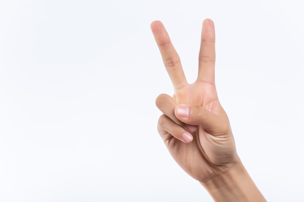 Closeup of isolated on green adult female hand counting from 0 to 5 Woman shows fist fist then one two three four five fingers Manicured nails painted with beautiful pink polish Math concept