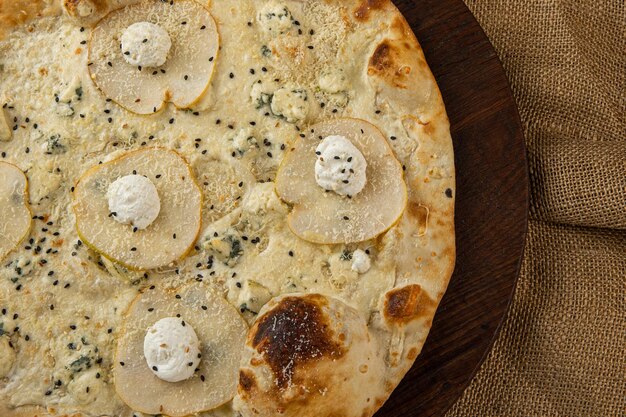 Closeup of an italian pizza with prosciutto ham green olives and rucola