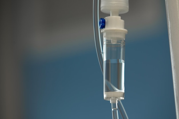 Closeup of IV tube Action Dropper with drug slowly dripping down tube IV tubes for sick patient after surgery