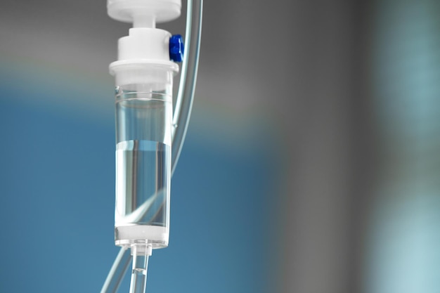 Closeup of IV tube Action Dropper with drug slowly dripping down tube IV tubes for sick patient after surgery