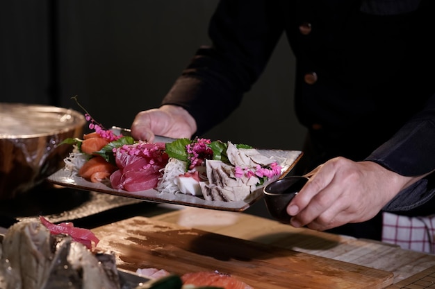 Closeup of a Japanese chef preparing to cook Japanese food Make sushi at a traditional Japanese restaurant on a chopping board