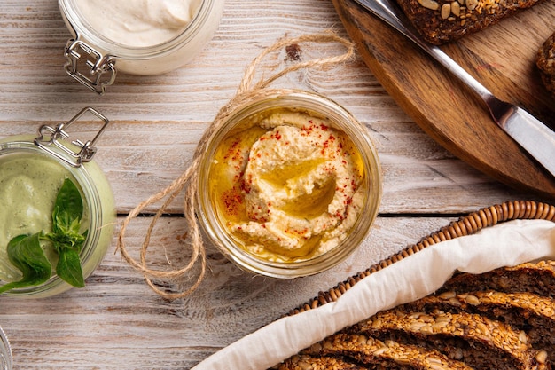 Closeup on a jar of appetizing hummus spread