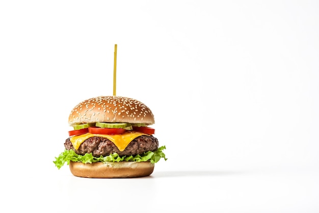 Photo closeup of a juicy cheeseburger with lettuce and tomato on a white background