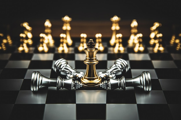 Closeup king chess stand on falling chess concepts of competition challenge of leader business team or teamwork volunteer or wining and leadership strategic plan and risk management or team player