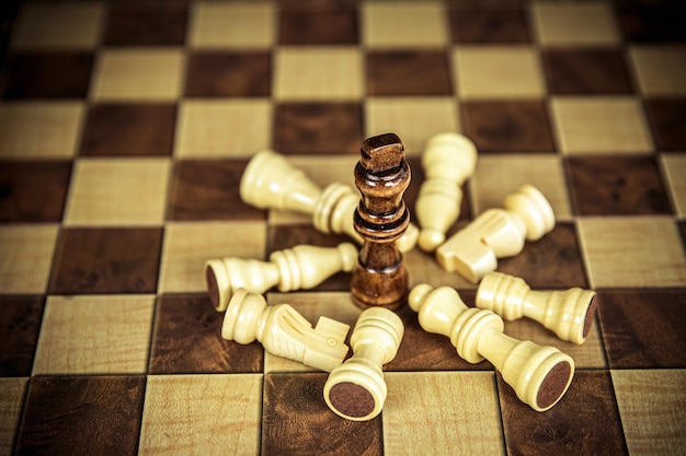 Closeup king chess standing on falling chess concepts of wining