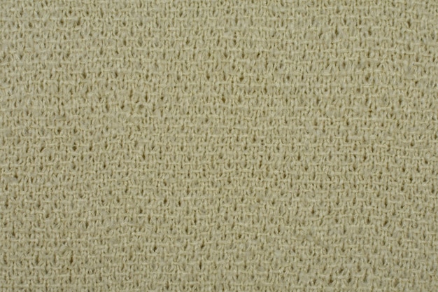 Closeup of knitted beige woolen texture