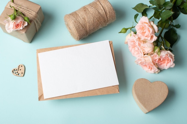 Closeup of a kraft envelope on the background of a gift and a bouquet of bush roses