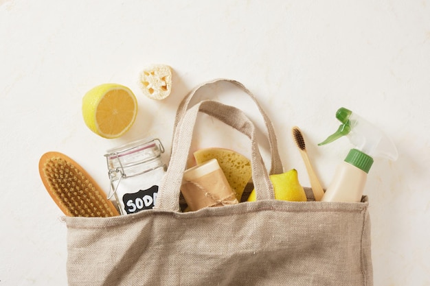 Closeup of labeled can of soda lemon and other eco friendly cleaning supplies in cloth bag no waste living