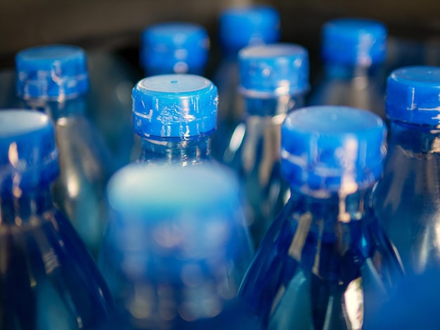 Closeup of Large Number of Packed Blue Bottled Drinking Water with Blue Capsdrinking water bottle