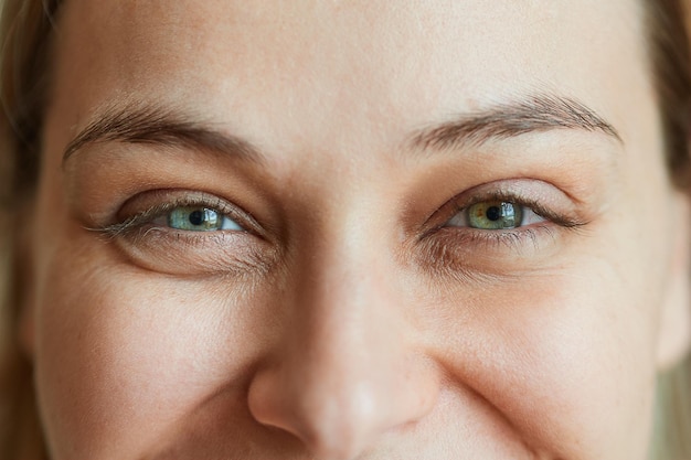 Closeup laughing eyes of a young beautiful woman