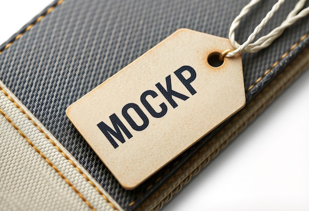 Photo closeup of a leather tag with the word quotmockupquot written on it