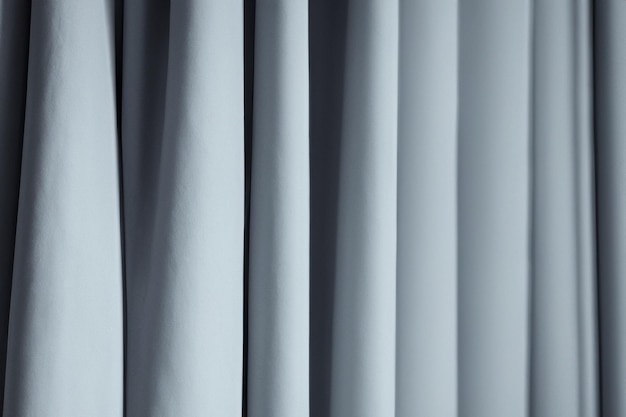 Photo closeup of light blue silky curtains with folds