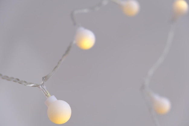 Closeup light chain decoration festive lights garland light bulbs on string wire selective focus