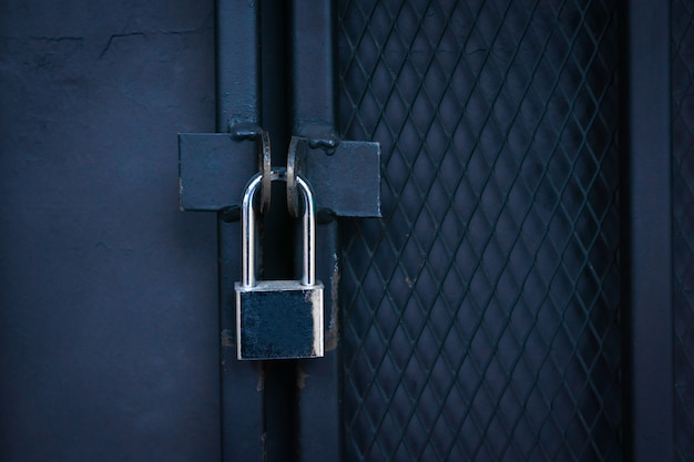 Closeup Locked Gate ,Padlock on a metal Iron gate.