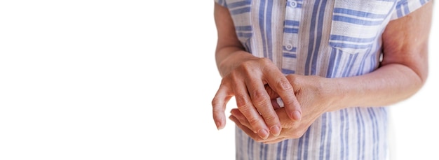 Closeup long banner of an old woman's hand with arthritis on white background