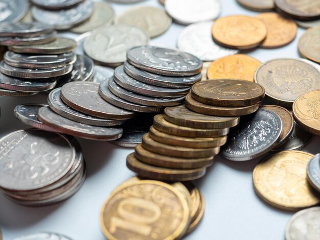 Closeup of a lot of Russian ruble coins on a white background The concept of the economy of growth development Budget currency Risks banks Side view selective focus