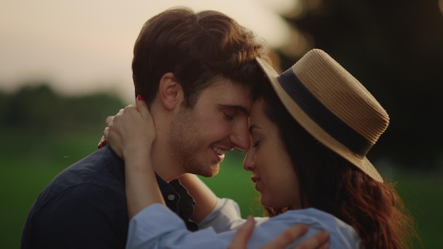 Closeup love couple dancing on field in slow motion Sensual people moving in dance outside Portrait of romantic man and woman spending time at romantic date in park at sunset