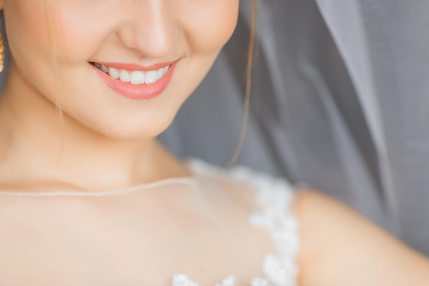 Closeup of lower half of face of the bride with a cute smile