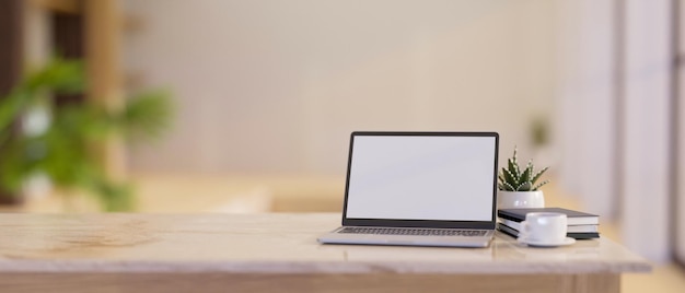 Closeup Luxury bright workspace with laptop mockup and copy space on white marble tabletop