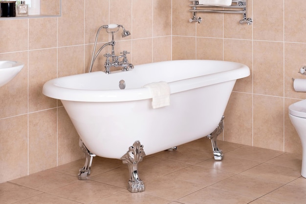 Closeup of a luxury vintage bathtub with a shiny metal faucet