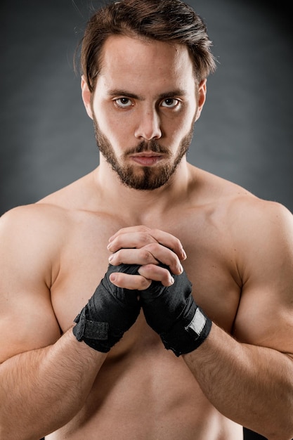 Closeup of a male boxer's hand with Boxing bandages Fists of a fighter before a fight or training in the gym The concept of sport