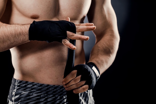 Closeup of a male boxer's hand with Boxing bandages Fists of a fighter before a fight or training