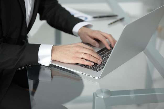 Closeup of male hands typing on notebook compute