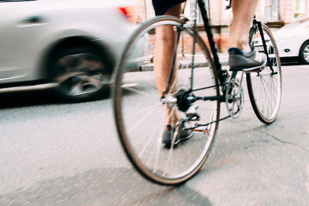 Closeup of male legs racing on bicycle