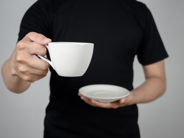 Closeup man hand holding coffee cup studio shot