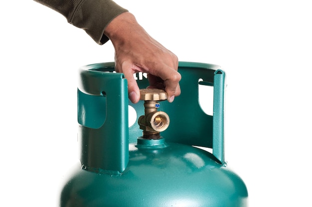 Closeup man's hand operating valve of LPG cylinder for cooking