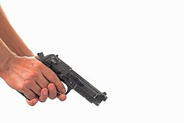 Photo closeup of a mans hand inspecting and checking a gun with a loaded magazine