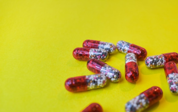 Closeup of many capsule on yellow background. groups of capsule.