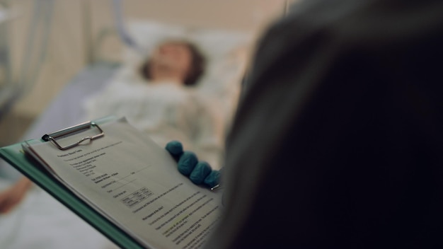 Closeup medical clipboard in doctor hands Therapist checking patient history