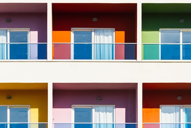 Closeup of a multicolored apartment building with glass balconies