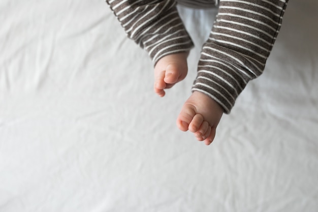 Closeup of a newborn baby feet with beautiful selective focus. Concept for maternity and tenderness