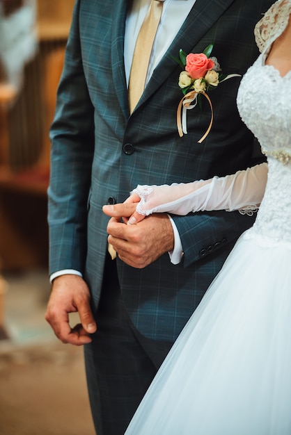 Closeup newly weds are holding each other's hand