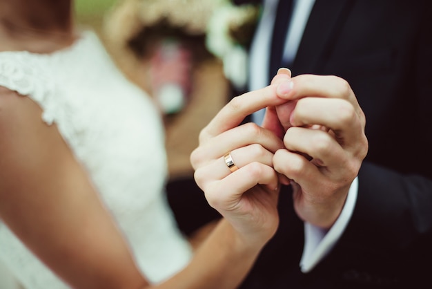 Closeup newly weds show their wedding rings while dancing