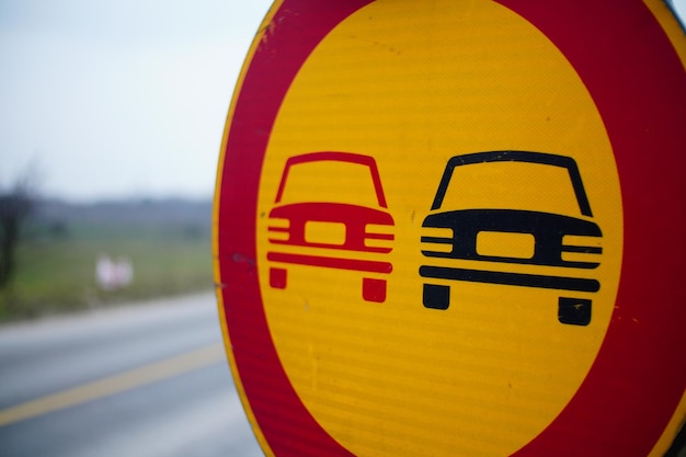 Closeup of a NO OVERTAKING sign along the road