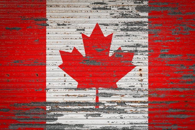 Closeup of old metal wall with national flag of Canada Concept of Canada exportimport storage of goods and national delivery of goods Flag in grunge style