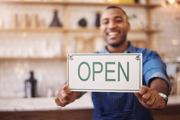 Closeup of open sign man and owner of shop store and advertising notice of retail trading time services and information Hands of happy cafe worker with opening banner welcome and startup poster