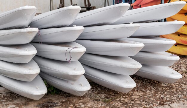 Closeup of paddle surf tables piled up on the shore