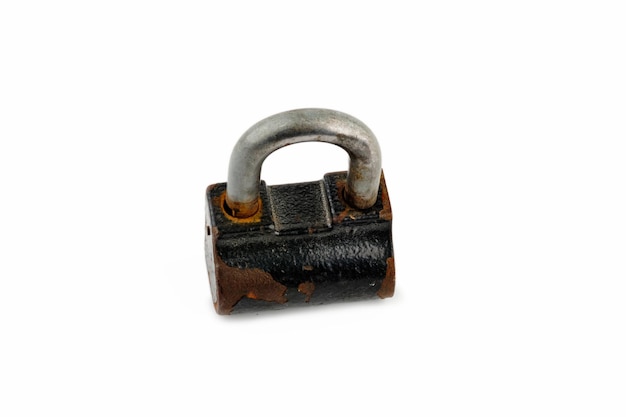 Photo a closeup of a padlock with fragments of rust is closed top view on white