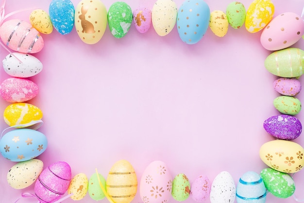 Closeup of painted eggs of different colors on a lilac background Design for Easter greetings