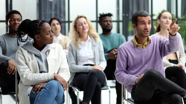 Closeup of people chatting sitting in a circle and gesturing